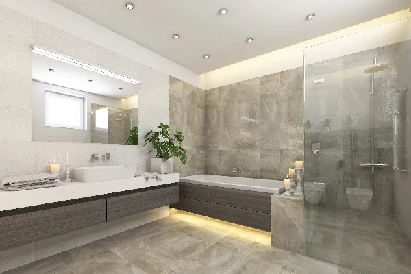 Modern bathroom with a floating vanity, large mirror, bathtub, glass-enclosed shower, candles, a window, and potted plant, decorated in neutral tones and ambient lighting.