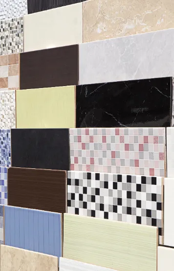 A display of various rectangular tiles in different colors, patterns, and textures, arranged in a grid on a vertical surface.